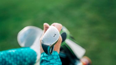 GOLF Top 100 Teacher John Dunigan explains why the 7-iron is the ideal warmup club, and shares ways to use it to get loose before a round